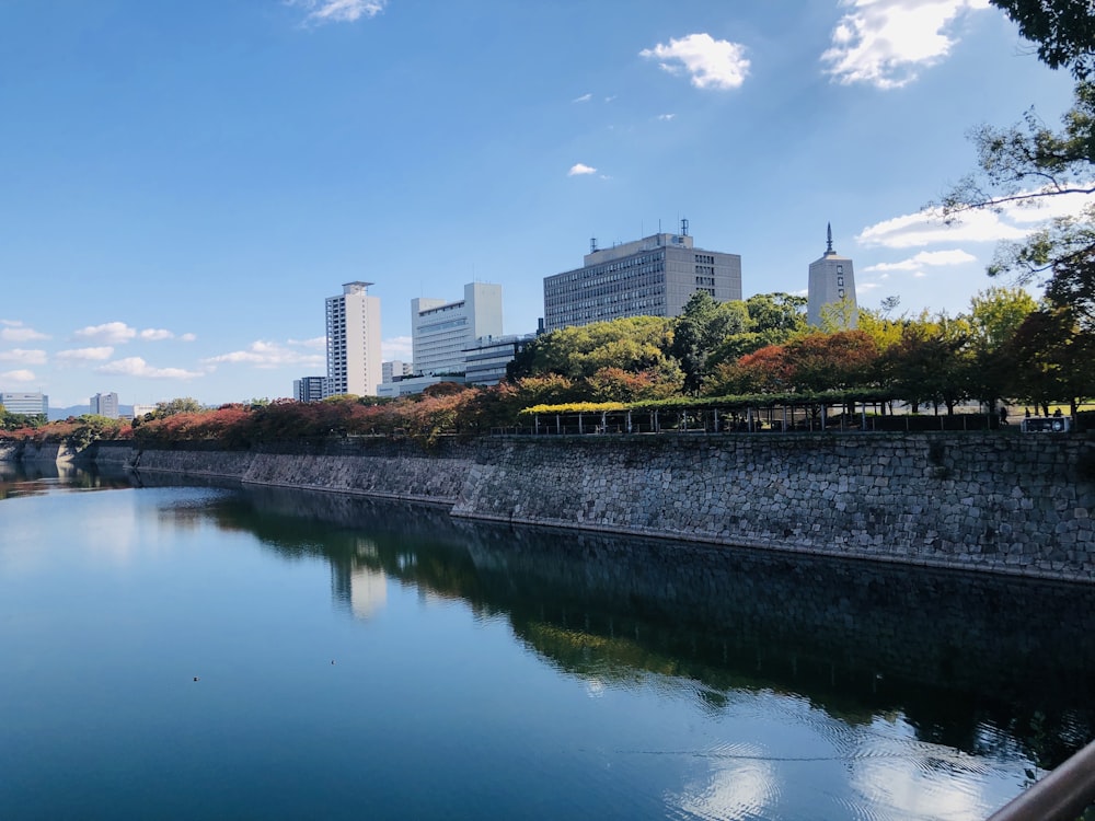 body of water near city buildings during daytime