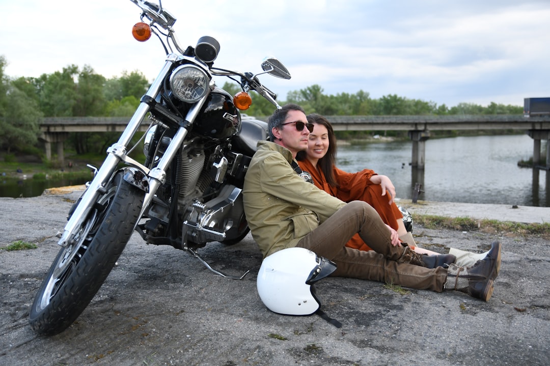 man in brown jacket and brown pants sitting on black motorcycle