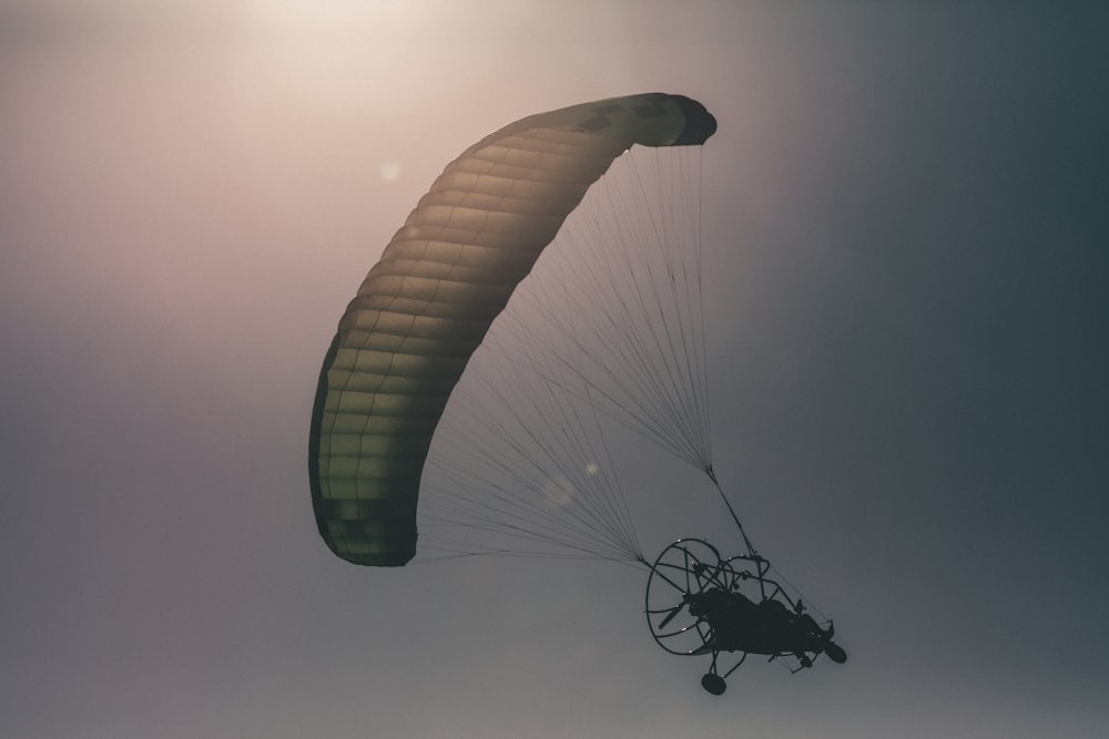 person riding parachute during daytime