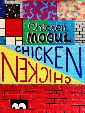 A street-smart mural backdrop behind a takeaway bag filled with chook chook chicken's signature pieces.