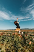 A child playing in a field of wildflowers.