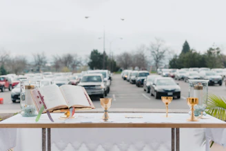 A serene outdoor altar decorated with candles and natural elements under a twilight sky.