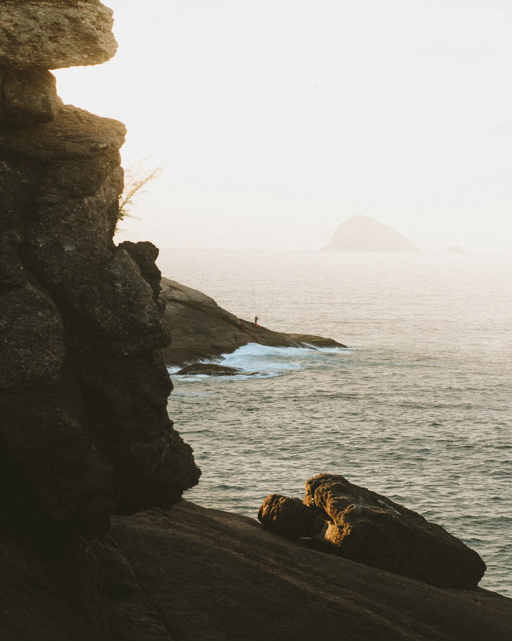 brown rock formation near body of water during daytime