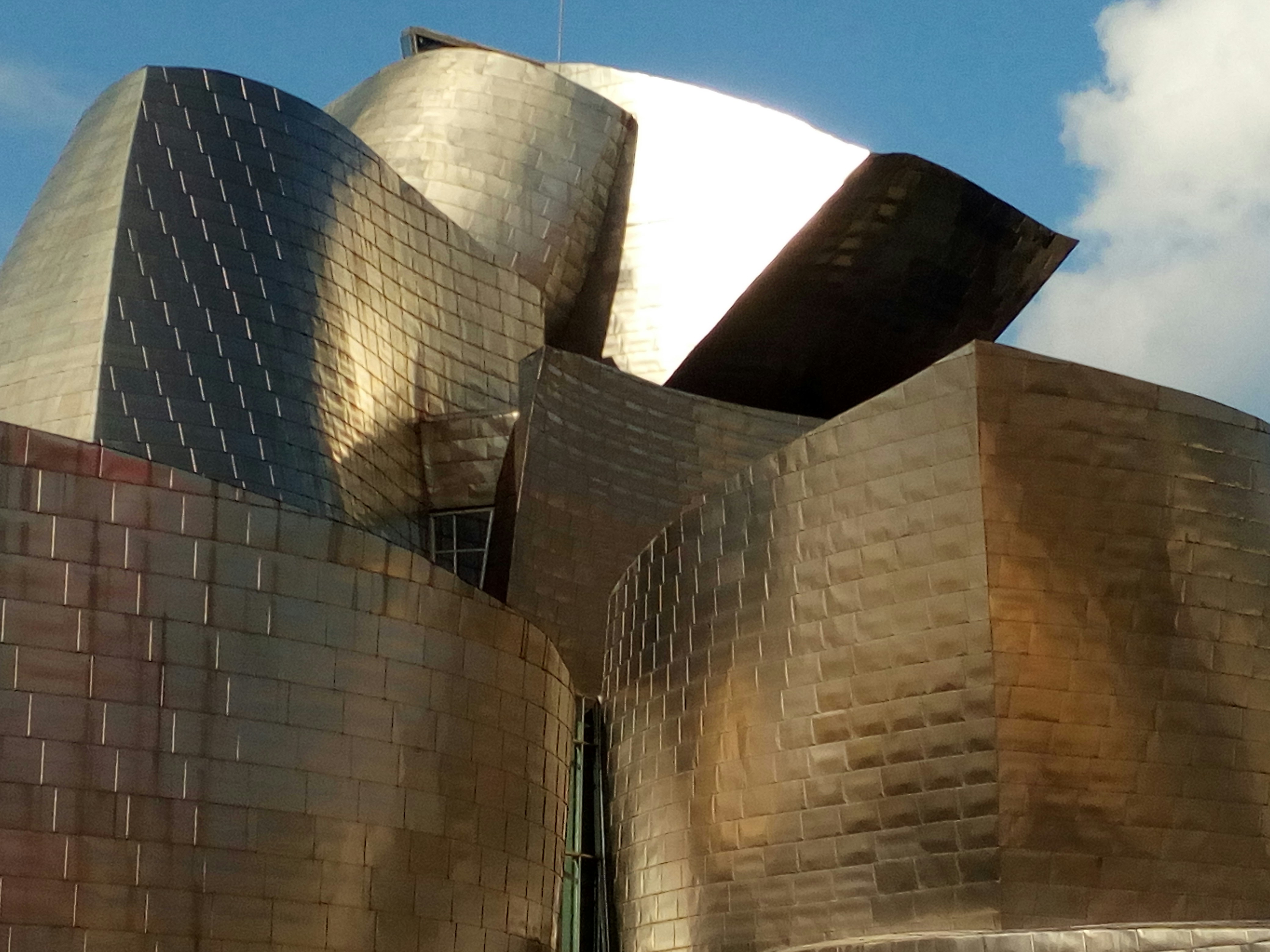 Completed metal building structure with steel panels, bright daylight exterior view