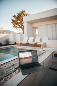 black laptop computer on white table
