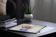 A graphic monitor showcasing colorful digital artwork with a stylus resting beside it.