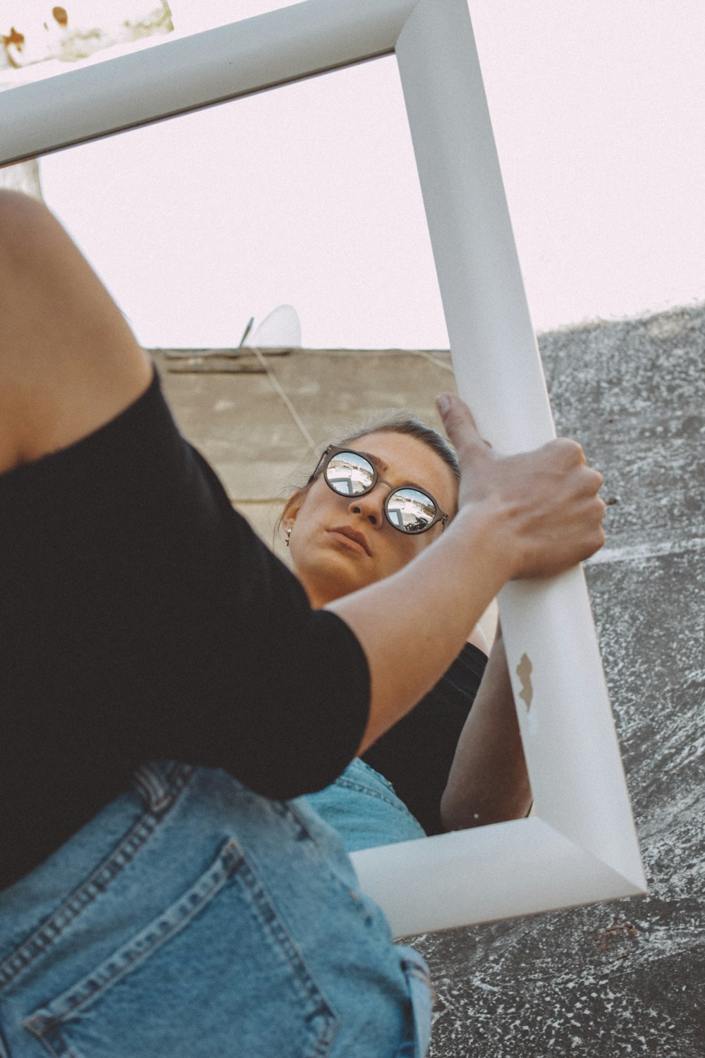 woman in blue denim shorts wearing brown sunglasses