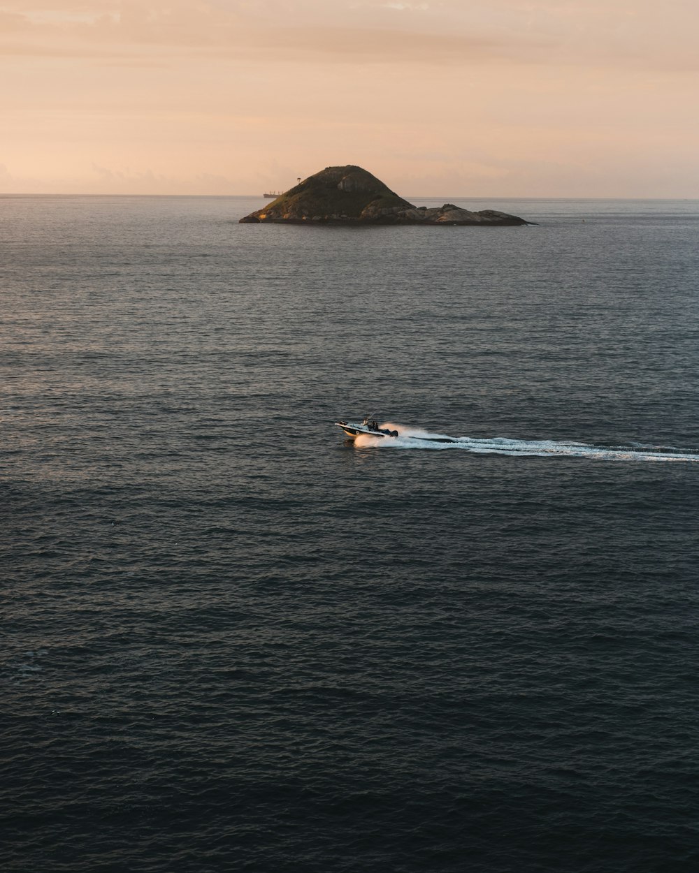 person riding on white and yellow personal watercraft on blue sea during daytime