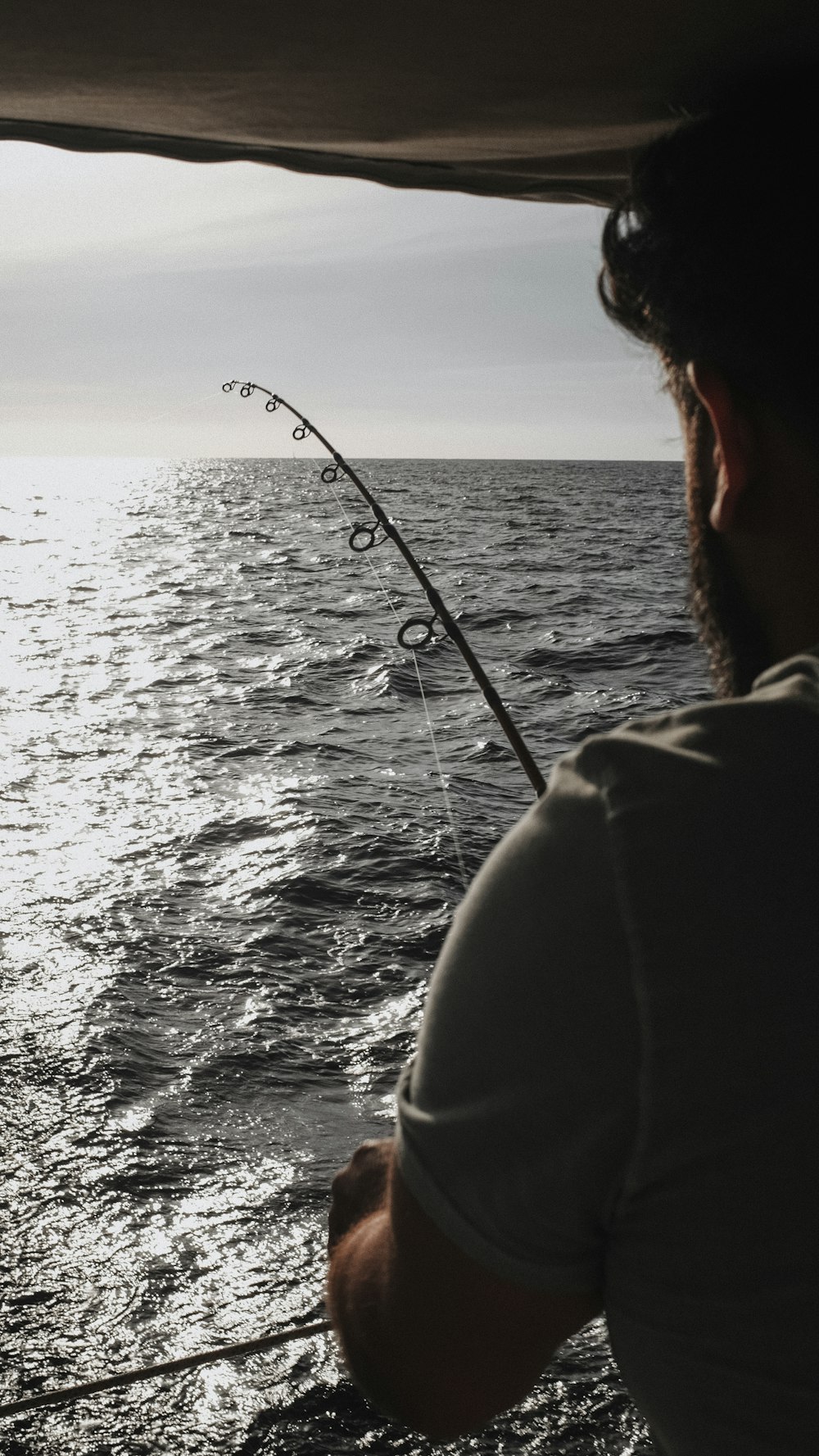 person in black jacket fishing during daytime