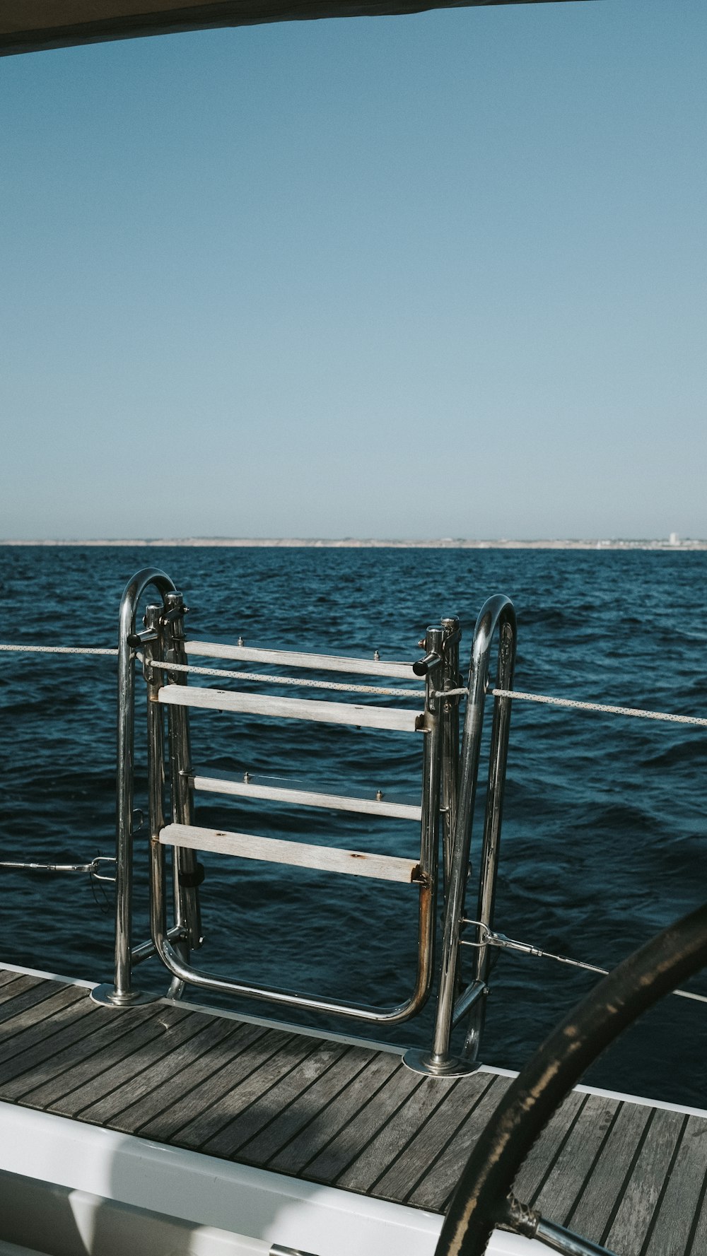 silver railings on blue sea during daytime