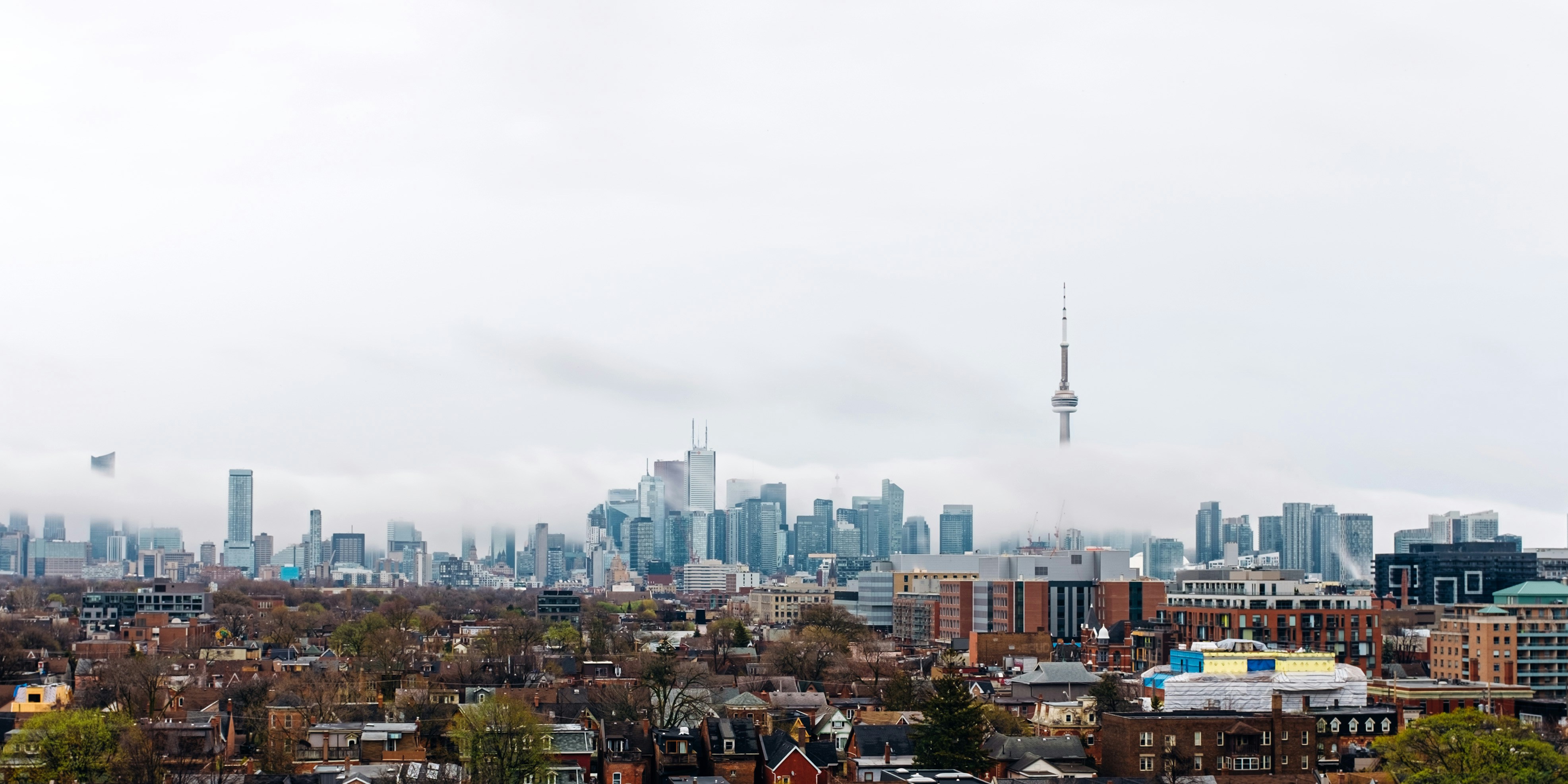 city with high rise buildings under white sky during daytime