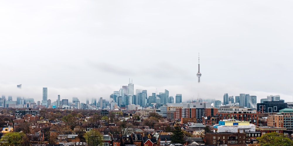 city with high rise buildings under white sky during daytime