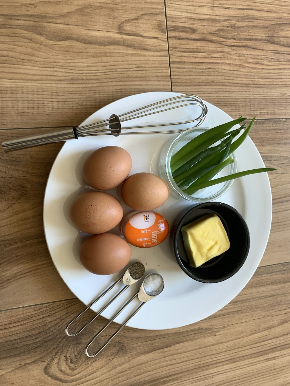 orange fruit on white ceramic plate beside stainless steel fork and knife