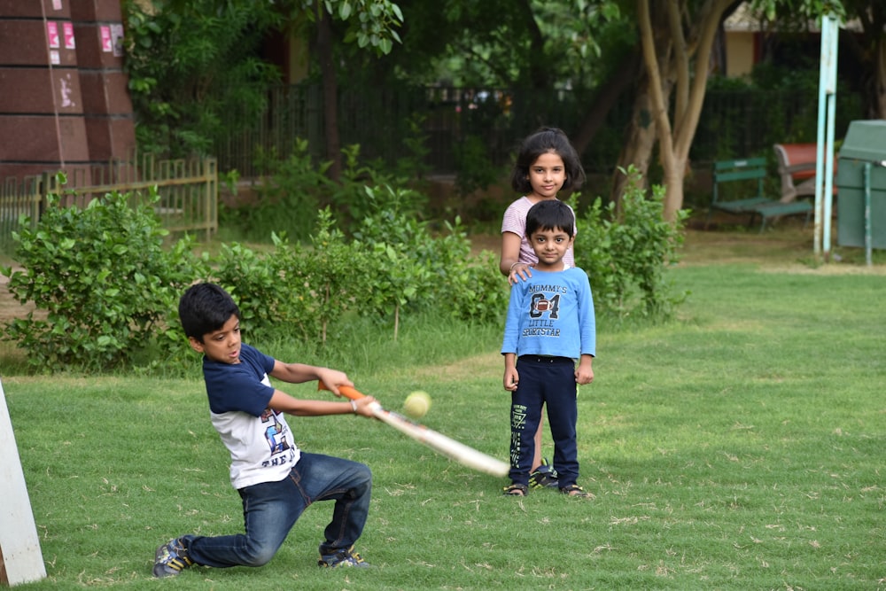 2 boys playing golf during daytime