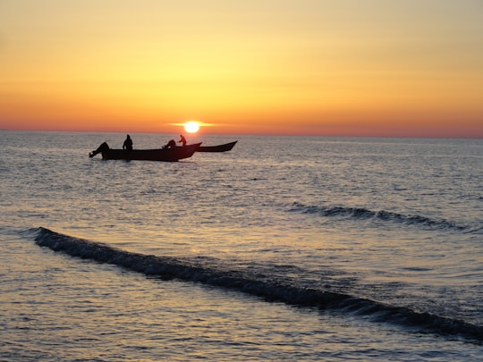 silhouette of person riding on red kayak on sea during sunset in Babolsar Iran