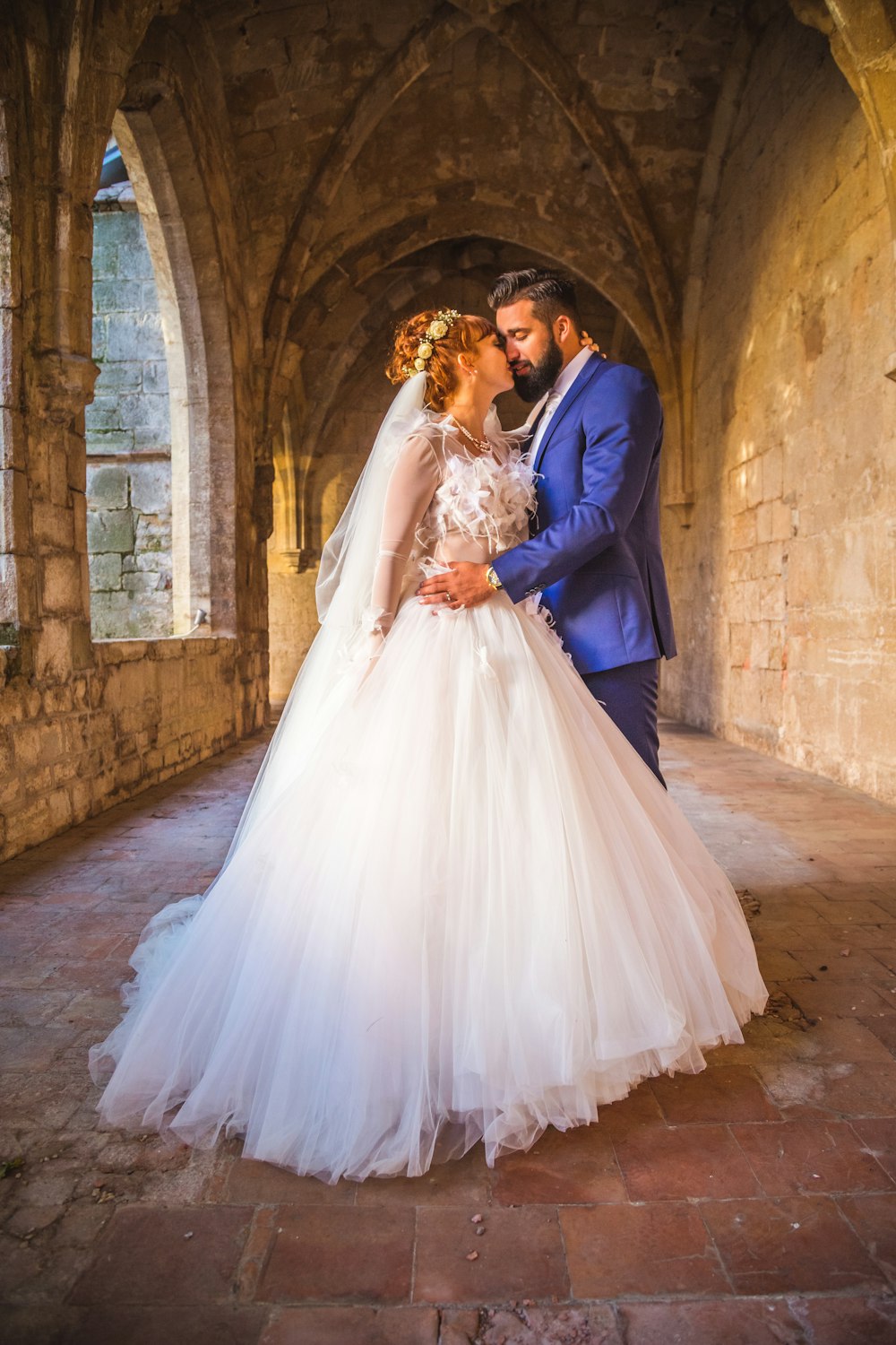 man in blue suit and woman in white wedding dress