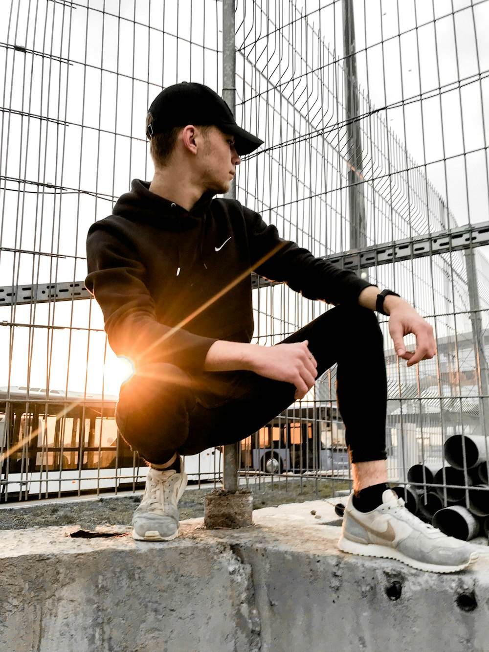 a man sitting on top of a cement block