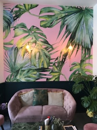 Cozy sofa area in a bright hotel suite with soft pink accents.