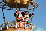 mickey mouse riding on swing ride