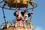 mickey mouse riding on swing ride