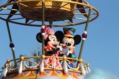 mickey mouse riding on swing ride