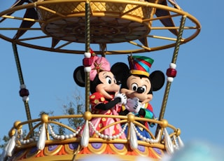 mickey mouse riding on swing ride