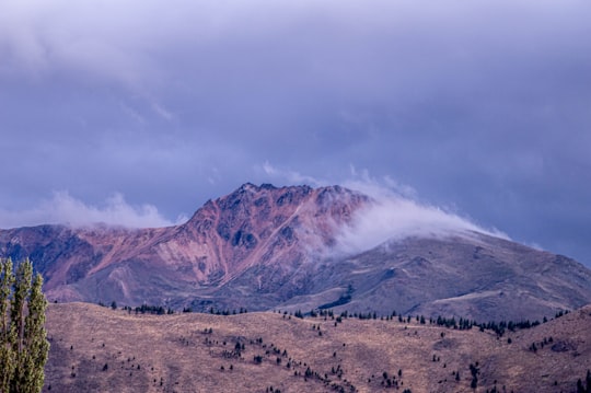 brown and white mountain under white clouds during daytime in Esquel Argentina