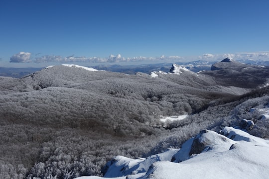 snow covered mountain under blue sky during daytime in Monti Alburni Italy