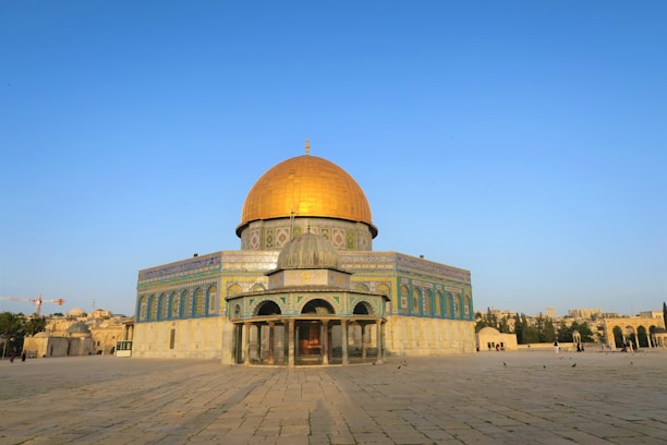 beige and green dome building under blue sky during daytime