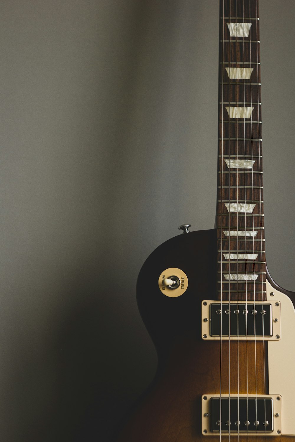 black electric guitar on black wall