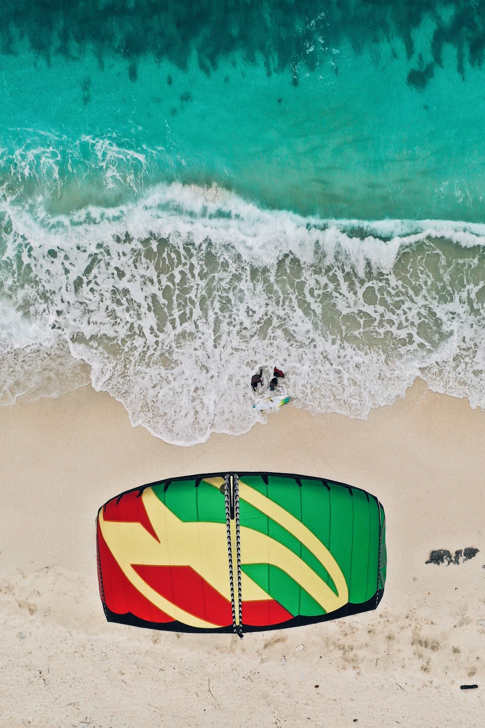 blue yellow and red surfboard on beach