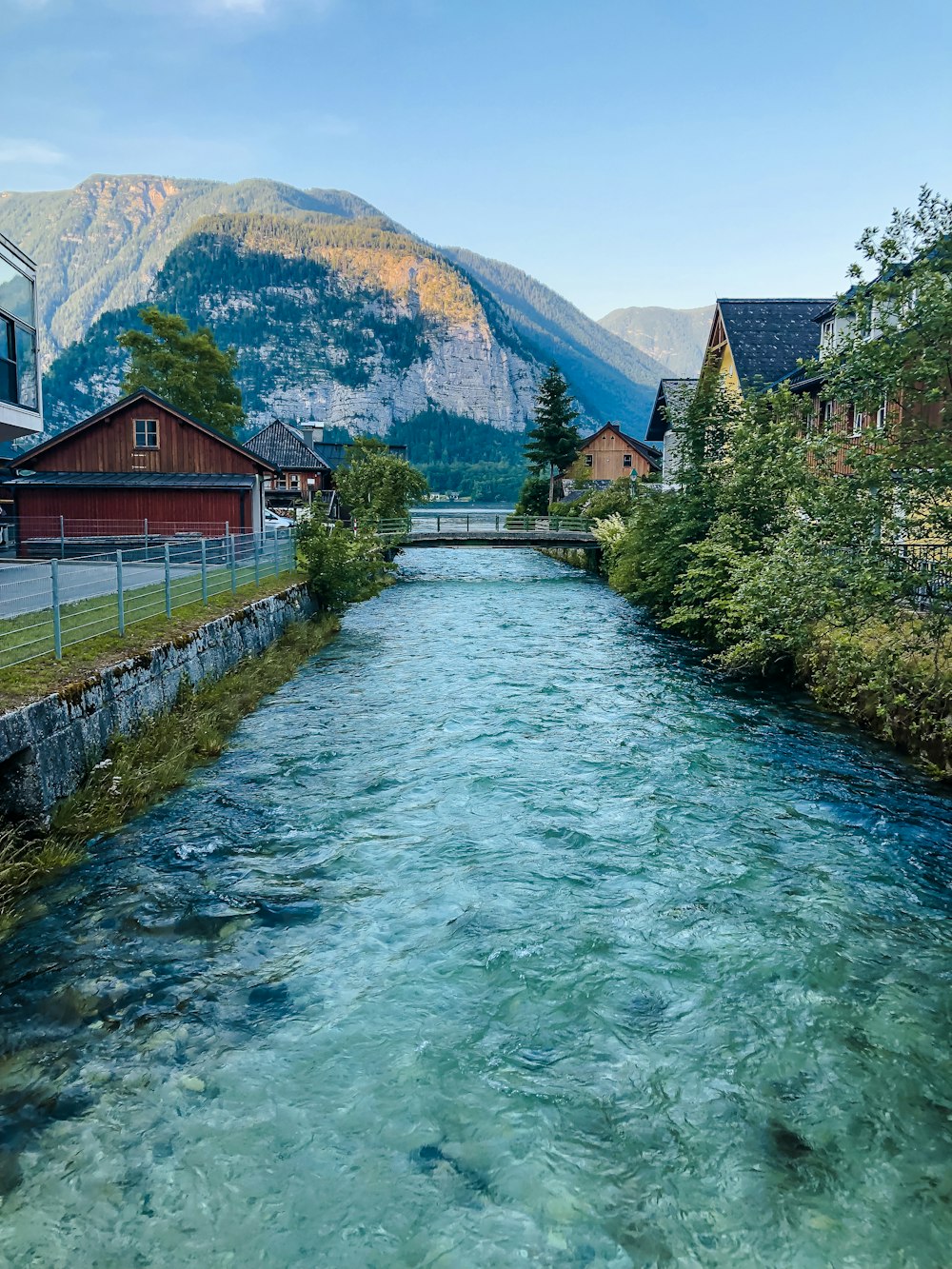 brown wooden house beside river during daytime