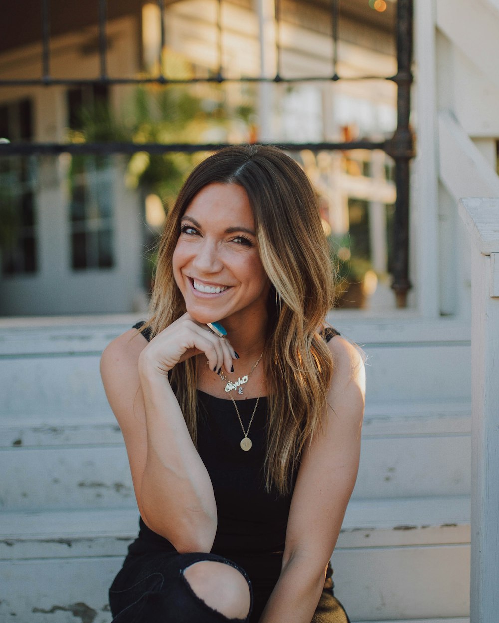 woman in black tank top smiling