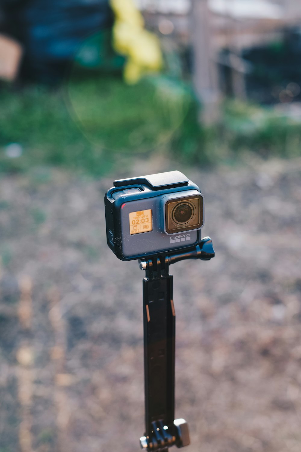 black and silver camera on brown wooden stand