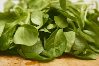 green leaves on brown wooden table