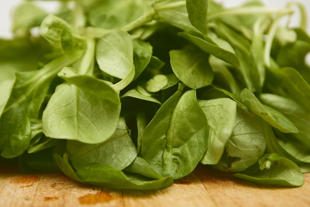 green leaves on brown wooden table