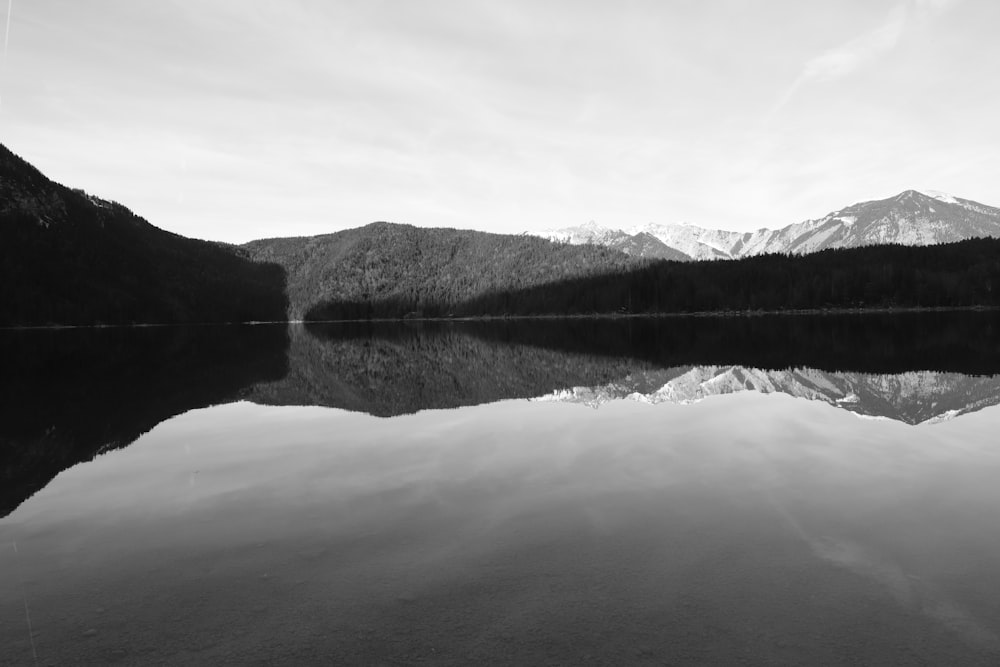 grayscale photo of lake and mountains