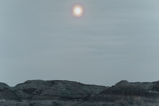 brown mountain under white sky during daytime in Dinosaur Provincial Park Canada