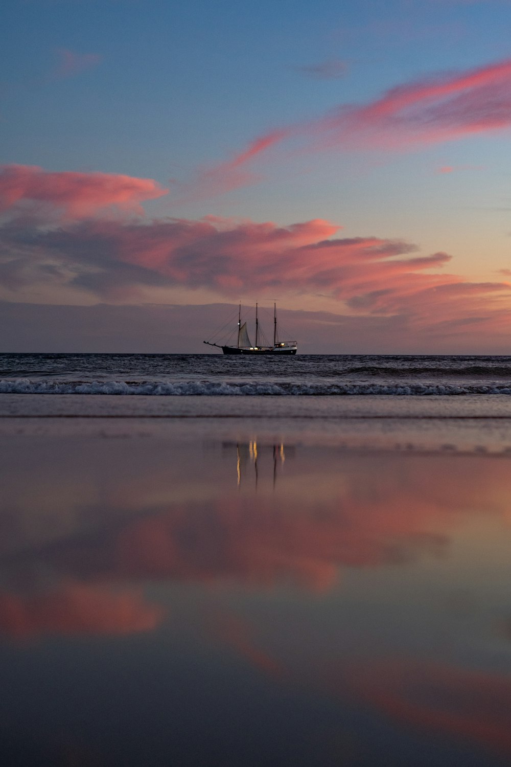 sailboat on sea during sunset