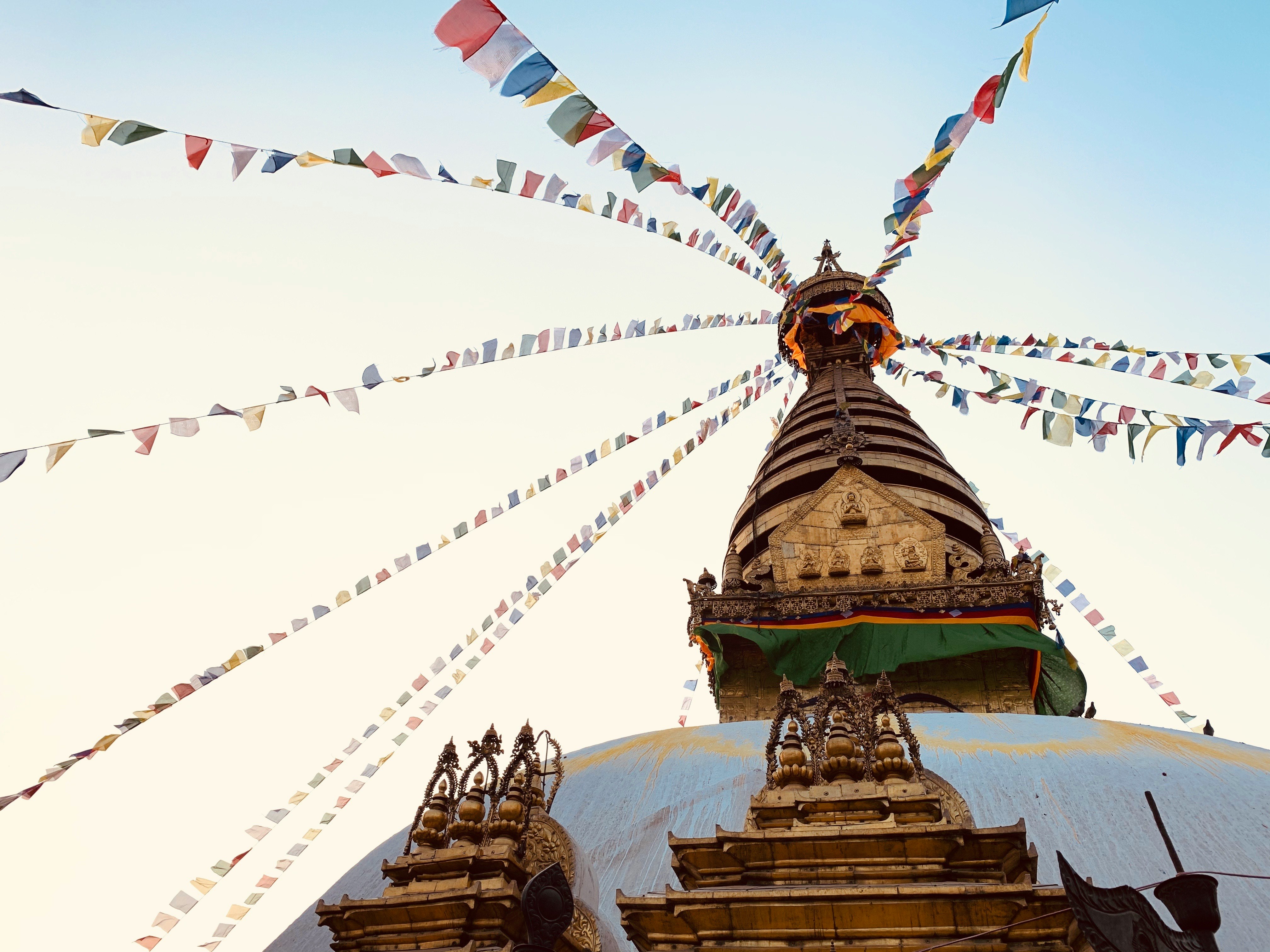 The Monkey Temple in Kathmandu is one of the greatest holy places in town. Its real name is Swayambhunath Stupa. After you climb 400 Steps to the top, you can enjoy one of the best views of the city of Kathmandu. On the last 10 steps you get this late afternoon view of the golden Stupa and its colorful prayer flags.