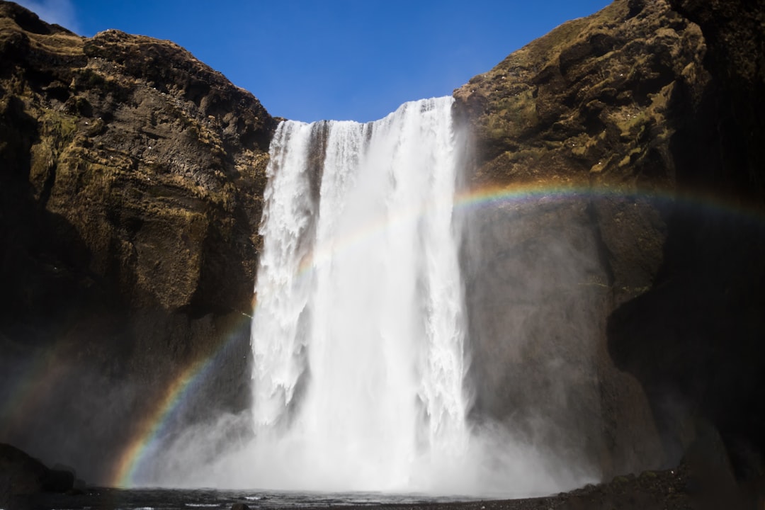 waterfalls under blue sky during daytime