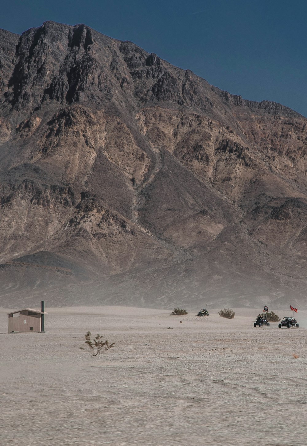 a desert landscape with mountains in the background