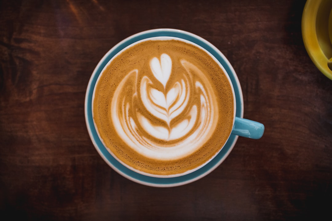 brown and white ceramic mug with coffee