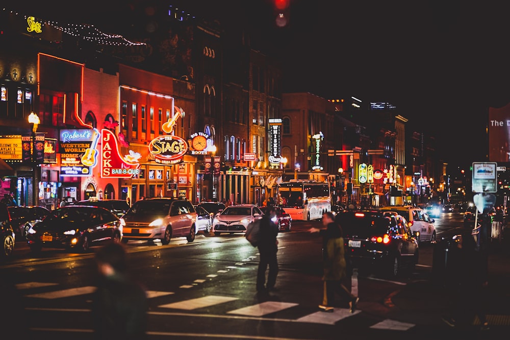 people walking on sidewalk during night time