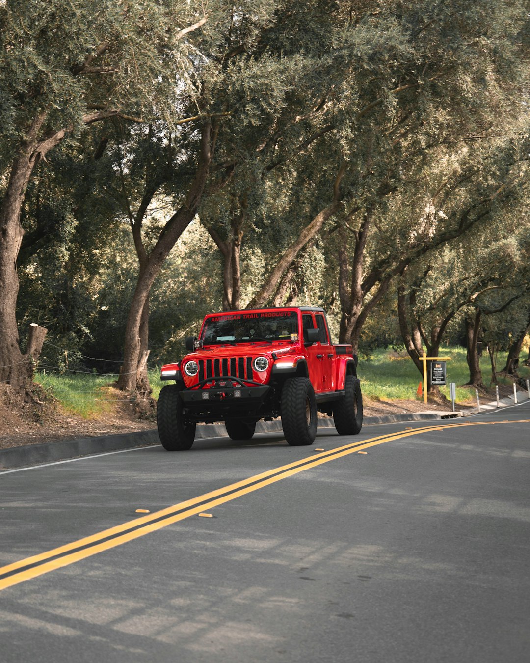 red and black jeep wrangler on road during daytime