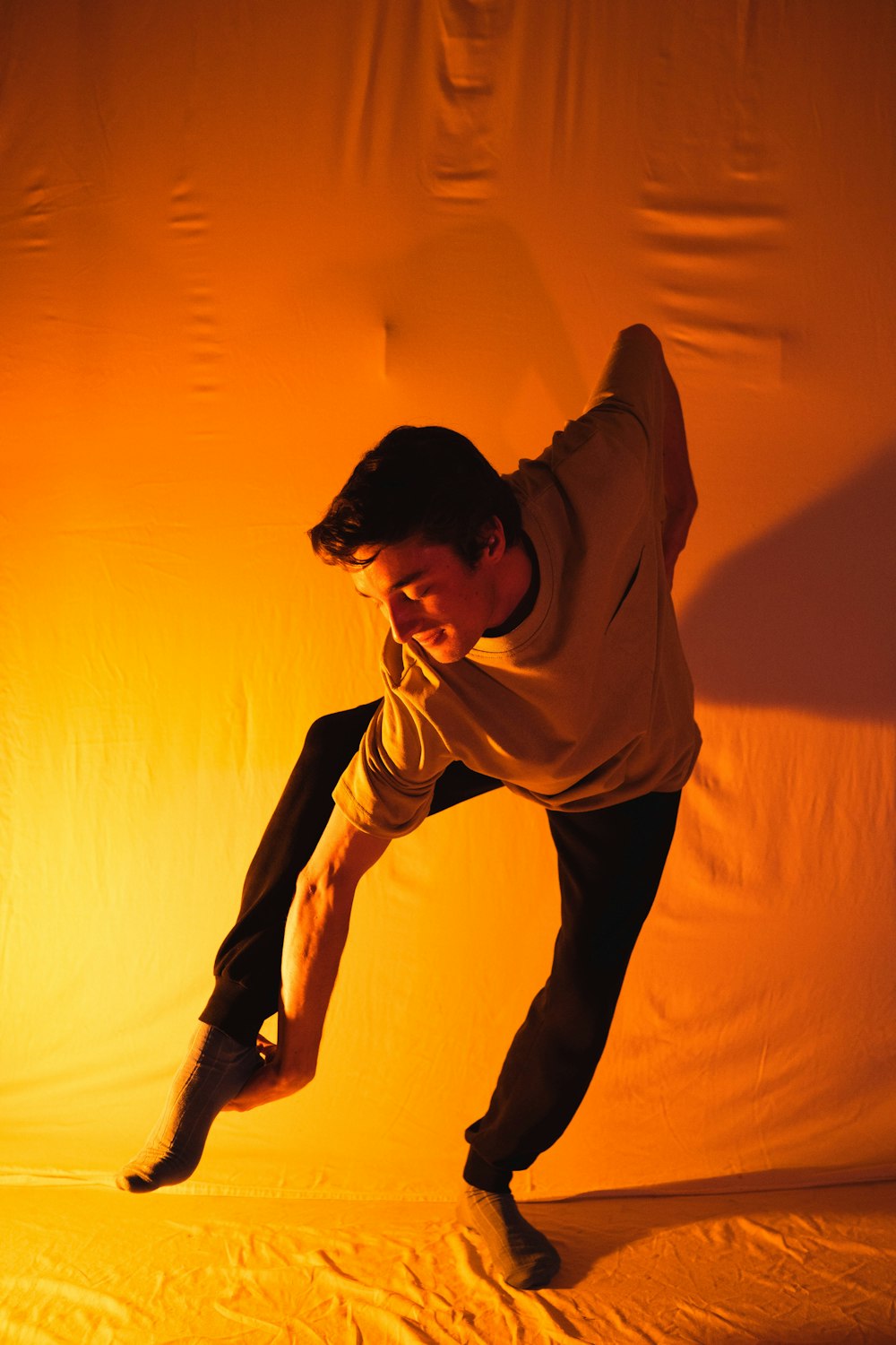 man in brown long sleeve shirt and black pants