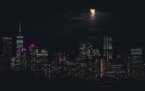 A moody silver and purple photograph of a nighttime cityscape.