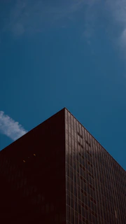 Modern residential building with sleek glass facades under a clear blue sky