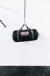 a boxing bag hanging from a rope in a gym