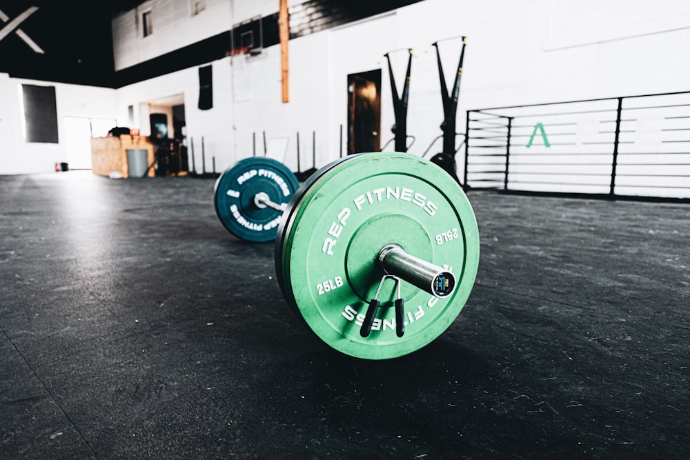 green dumbbell on black floor